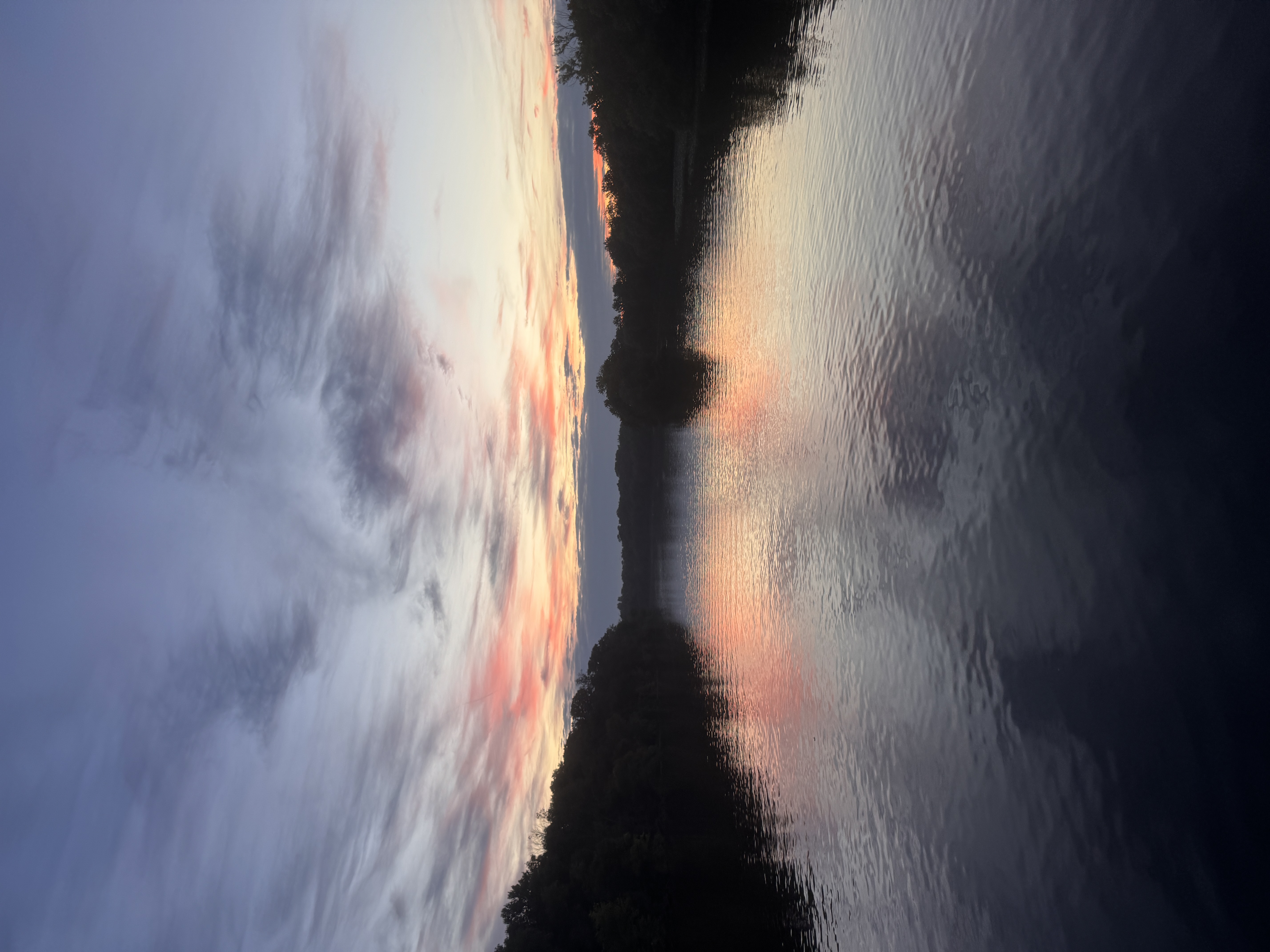 A shimmering lake beneath a rising sun