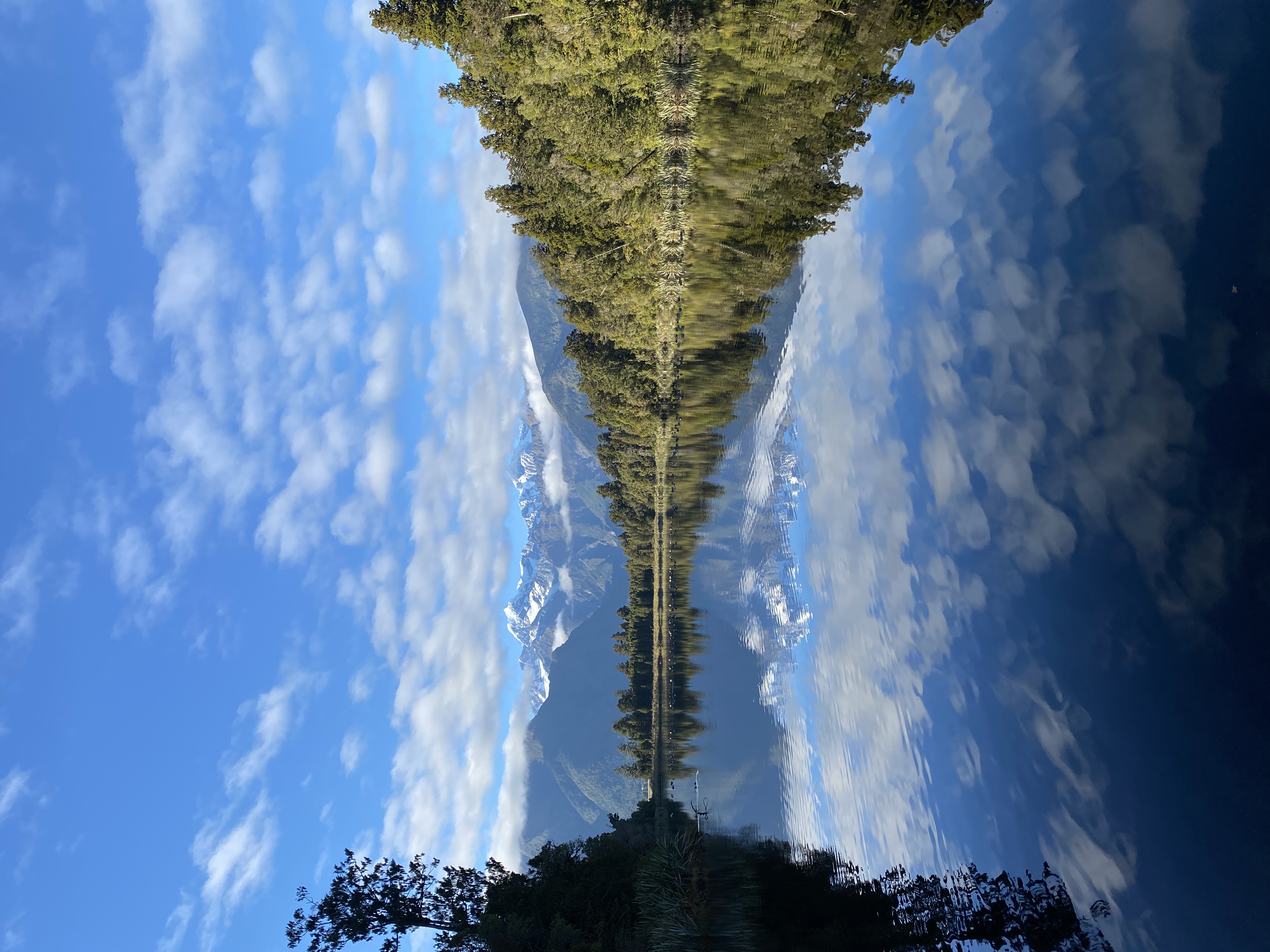 Mount Cook and Mount Tasman symmetrically reflected in the still lake surface