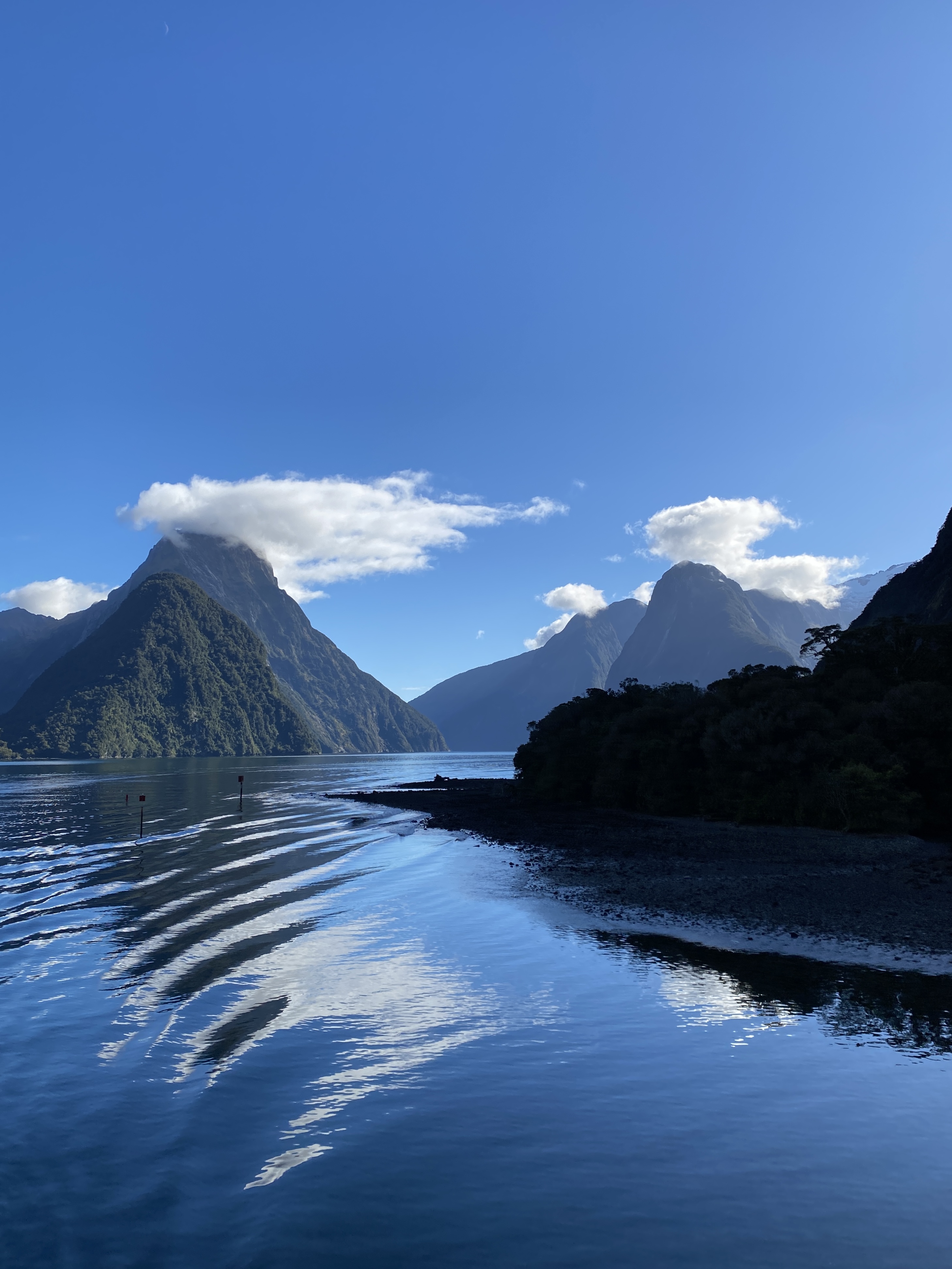 Cloud-covered peaks reflected in the glassy water