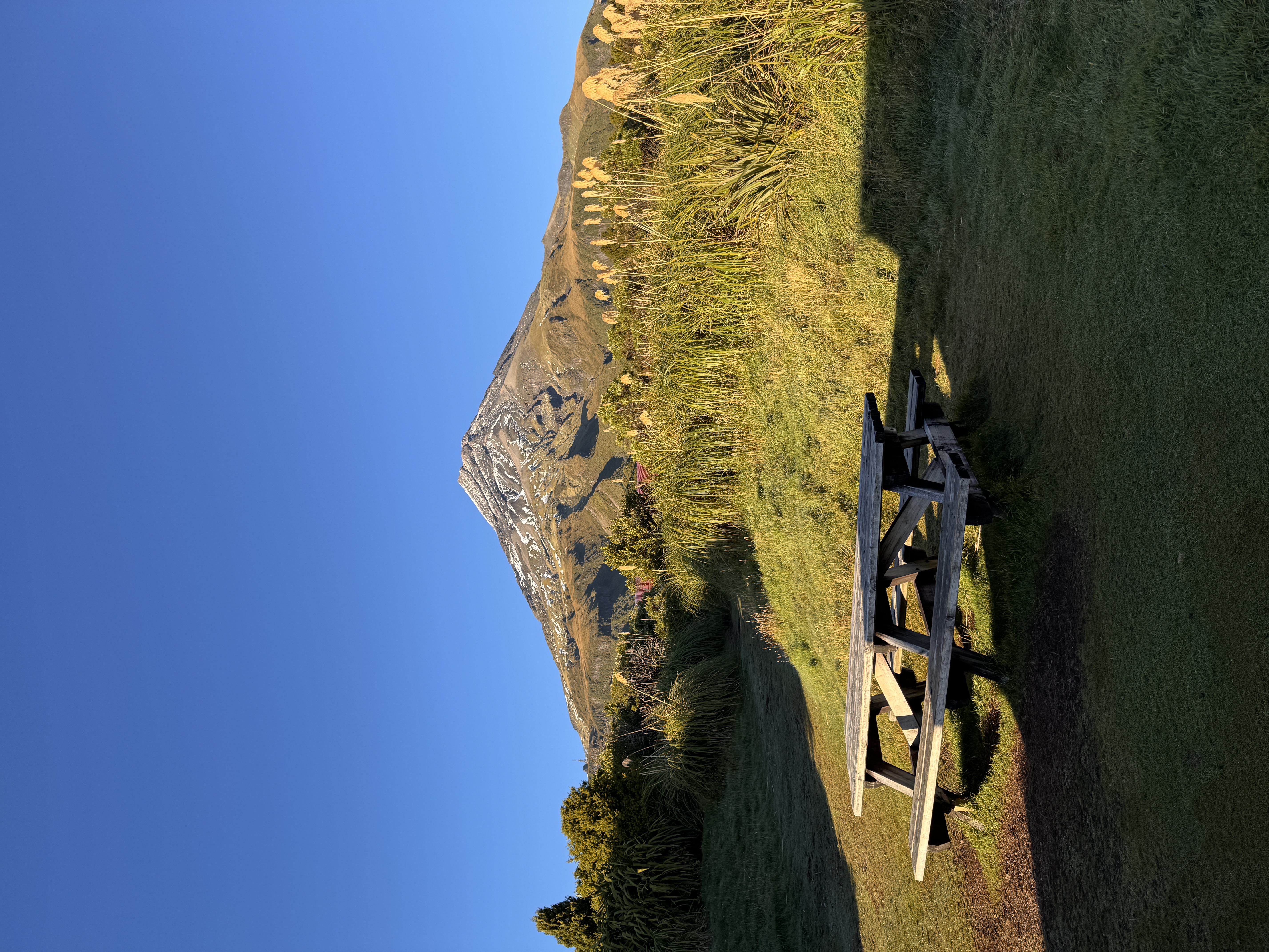 A volcanic peak rising out of grassy foothills