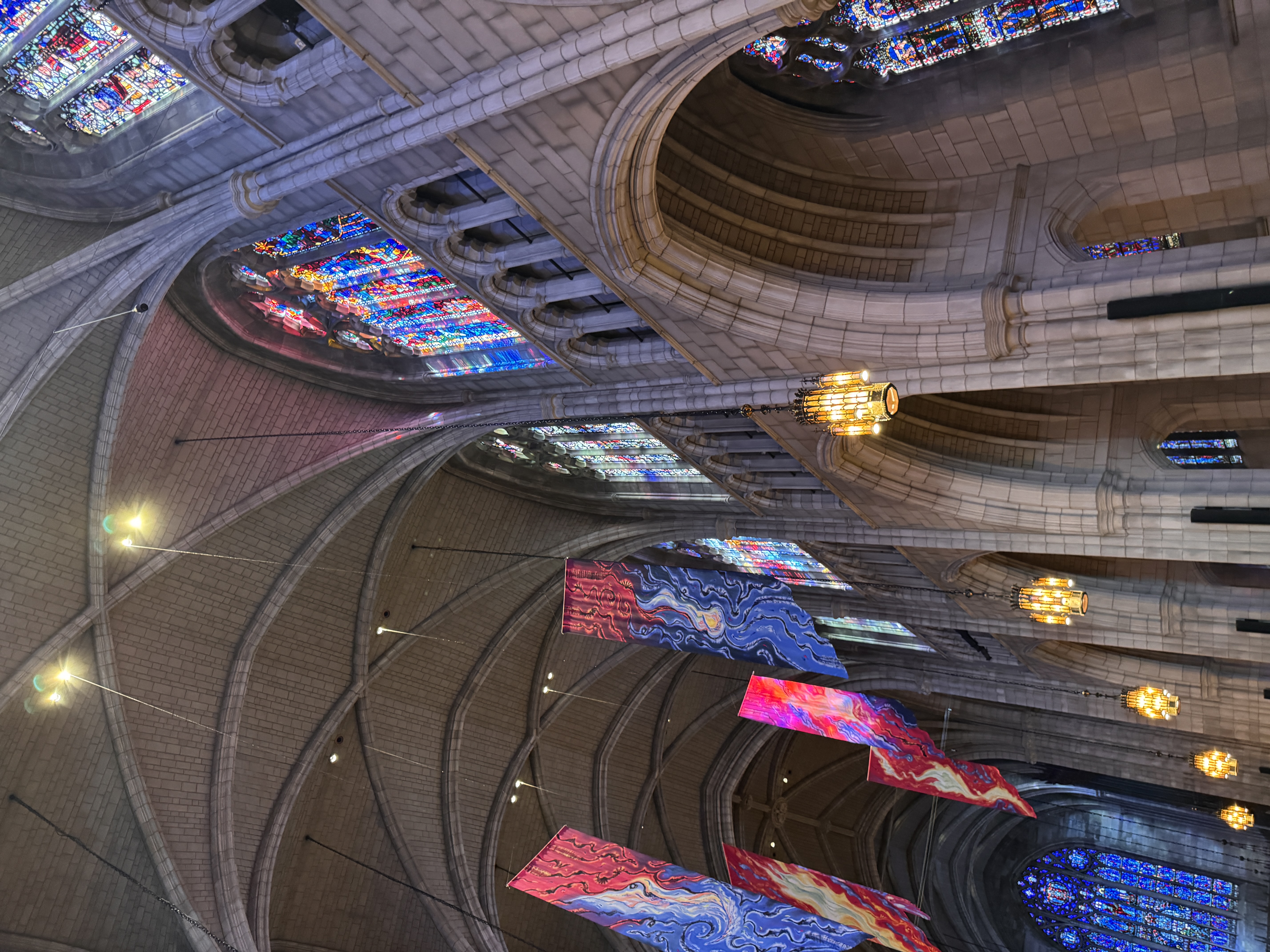 Stone arches, stained-glass windows, and colourful banners