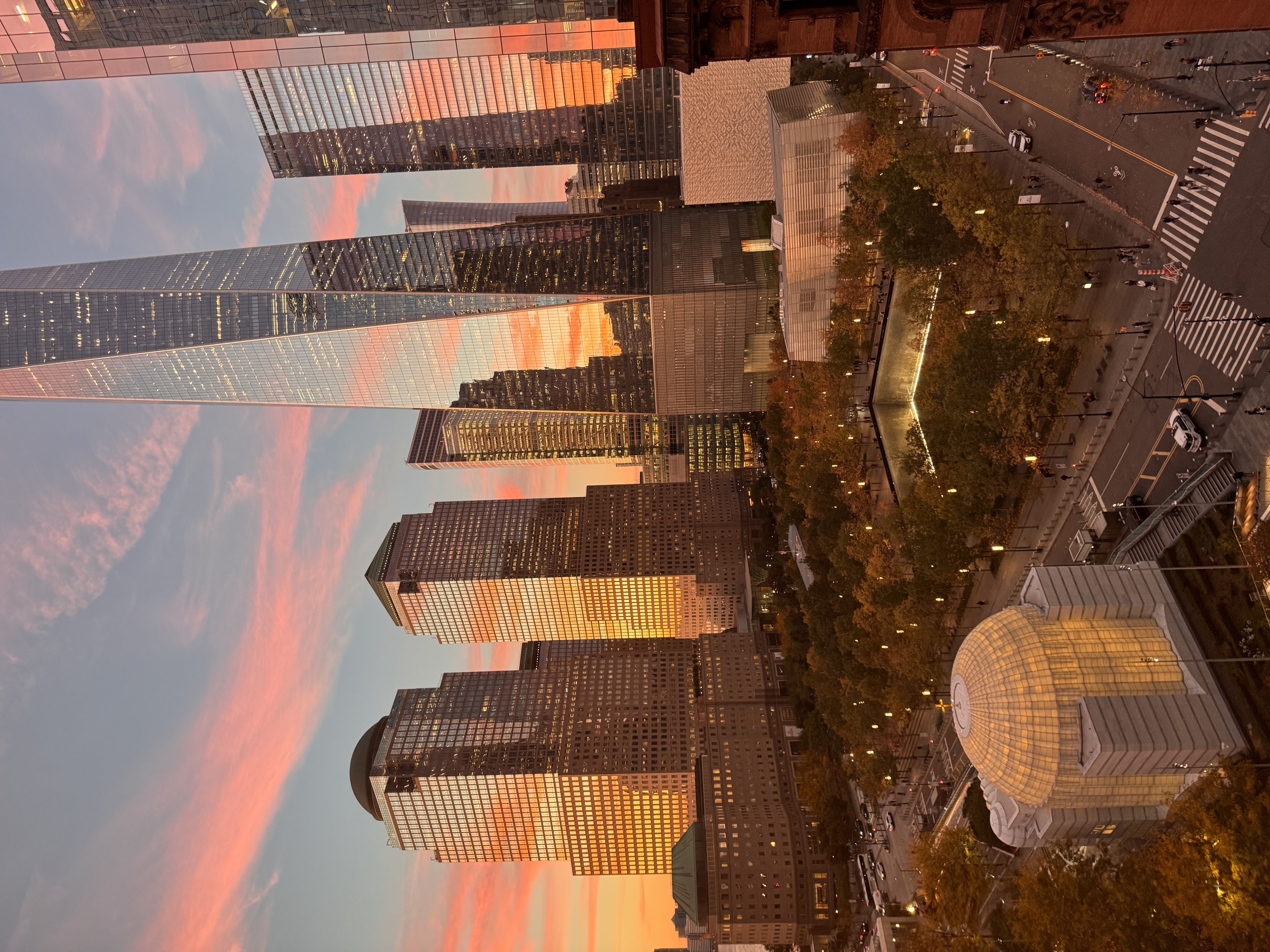 Tall buildings reflecting a pink sunset